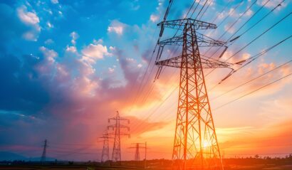 High voltage electric transmission tower. High voltage power lines on electric pylon against a sunset sky. Electrical infrastructure. Energy crisis. Electric power distribution. Energy distribution